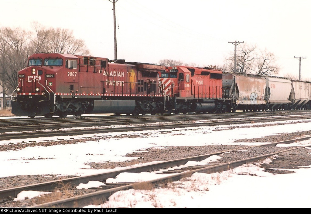 Grain train rolls west through University